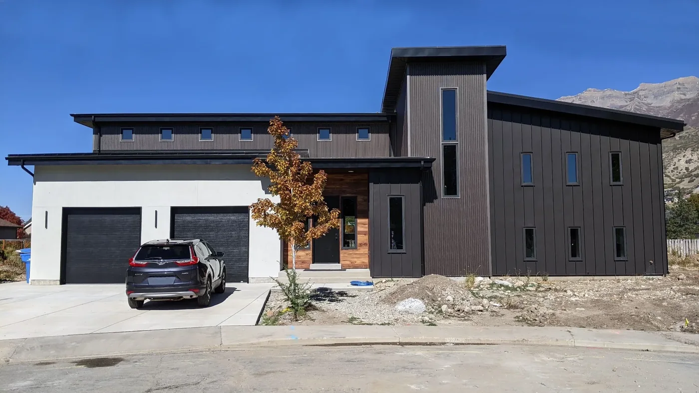 Modern custom home by Riddle Custom Construction, completed exterior at dusk